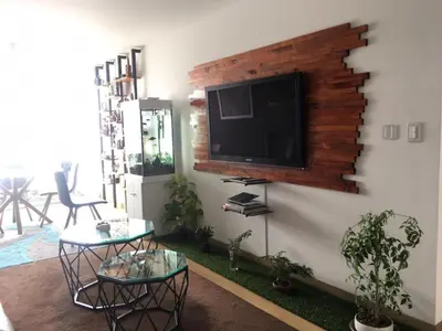 a living room with a flat screen tv on a wall at Precioso cuarto dentro de un apartamento centrico compartido in Lima