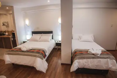 a hotel room with two beds with towels on them at Florez de la Villa in Huaran