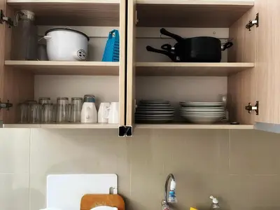 a kitchen cabinet with plates and utensils in it at Casa de Playa Barranca in Barranca