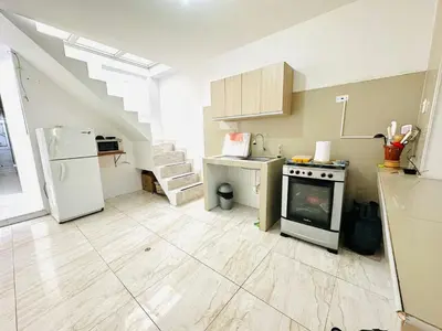 a kitchen with a stove and a refrigerator at Casa de Playa Barranca in Barranca