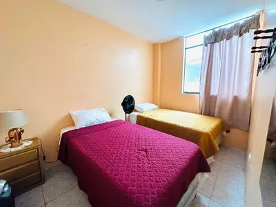 a bedroom with two beds and a window at Casa de Playa Barranca in Barranca