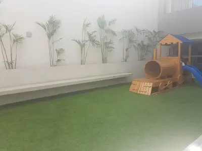 a playground in a room with palm trees on the wall at Lindo y Espacioso Departamento muy cerca a Miraflores in Lima