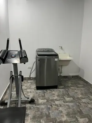 a bathroom with a trash can and a sink at MH Apartments Ica in Ica