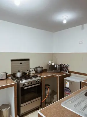 a kitchen with a stove and a counter top at MH Apartments Ica in Ica
