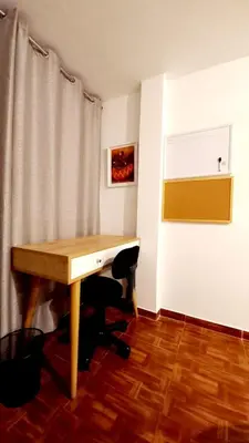 a desk in a room with a curtain and a table at Gorgeous Private Studio LIMA-Own Bathroom-Near Airport in Lima
