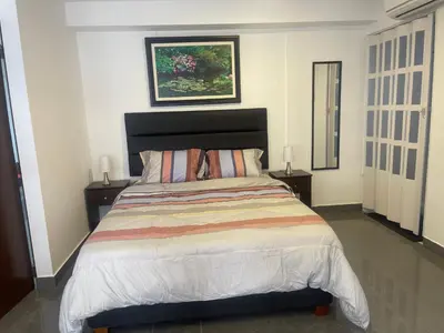 a bedroom with a large bed with two night stands at (10) Departamento de estreno centro de Mirafores in Lima