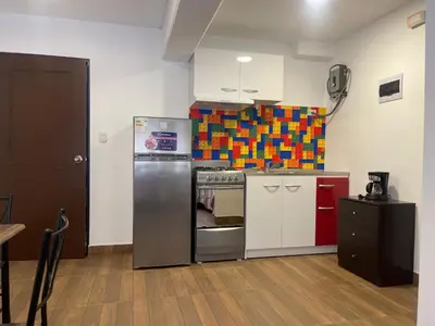 a kitchen with a stainless steel refrigerator and a stove at (12) Depto con inmejorable ubicación Miraflores in Lima