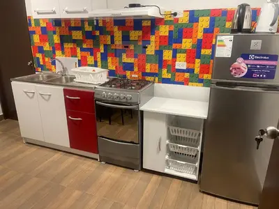 a toy kitchen with a stove and a refrigerator at 19 Departamento en el centro de Miraflores in Lima