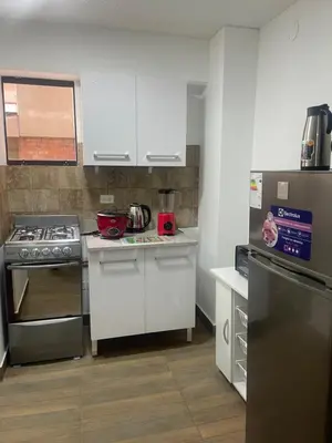a kitchen with white cabinets and a stove top oven at 15 Acogedor dpto de un ambiente en miraflores in Lima