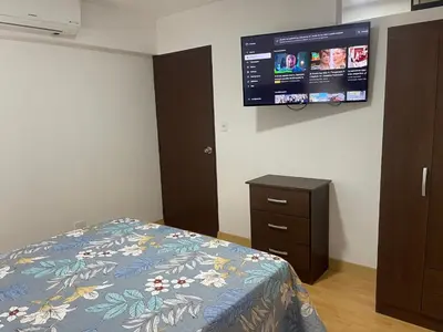 a bedroom with a bed and a tv on the wall at 16 Dpto con inmejorable ubicación en Miraflores in Lima