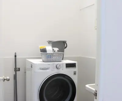 a washing machine with a basket on top of it at Black by Wynwood House in Lima