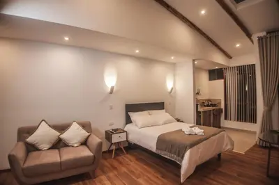 a bedroom with a bed and a couch at Flores de la Villa in Huayoccare