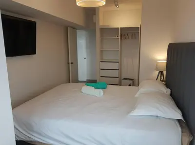 a bedroom with a large white bed with two pillows at Encantador apartamento en Miraflores in Lima