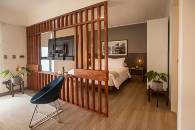 a bedroom with a bed and a blue chair at Solar by Wynwood House in Lima
