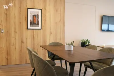 a dining room with a wooden table and chairs at Solar by Wynwood House in Lima