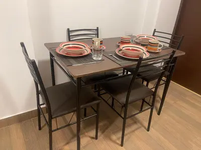 a dining room table with chairs and plates on it at 18 Departamento en la mejor zona de Miraflores in Lima