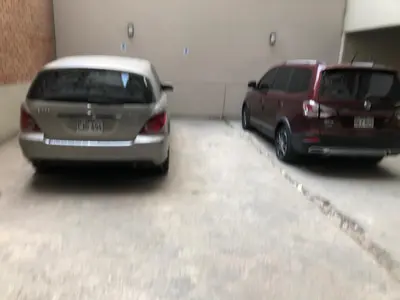 two cars are parked in a garage at 17 Dpto con inmejorable ubicación Miraflores in Lima