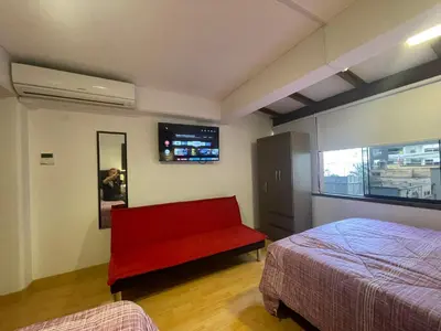 a bedroom with a red bed and a red bench at 17 Dpto con inmejorable ubicación Miraflores in Lima