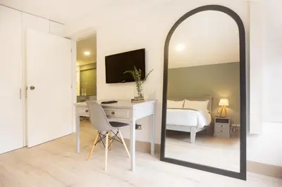 a bedroom with a mirror and a desk and a bed at San Martin 598 by Wynwood House in Lima
