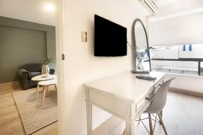 a living room with a white desk and a mirror at San Martin 598 by Wynwood House in Lima