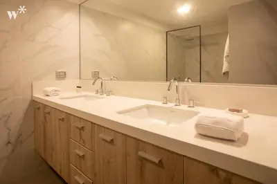 a bathroom with a sink and a large mirror at Alcanfores 1262 by Wynwood House in Lima