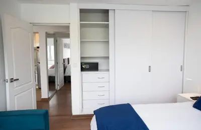 a bedroom with a white bed and a mirror at Apartment in Center of Miraflores in Lima