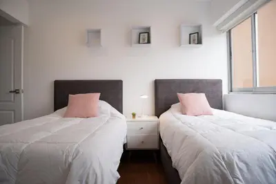 two beds sitting next to each other in a bedroom at Apartment in Center of Miraflores in Lima