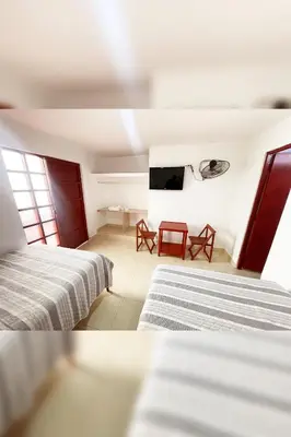 a hotel room with two beds and a television at LAS PALMERAS HOSTAL in Barranca