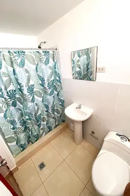 a bathroom with a toilet and a sink at LAS PALMERAS HOSTAL in Barranca