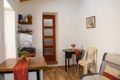 a small living room with a table and a chair at Santo Domingo in Ayacucho