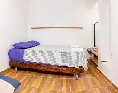 a bedroom with a bed on a wooden floor at Santo Domingo in Ayacucho