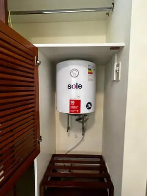 a room with a large white boiler on the wall at Bonito depa san isidro cama queen home office wifi y cochera in Lima