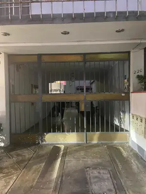 a garage door with a gate in a building at Departamento Cool & Comodo, San Isidro in Lima