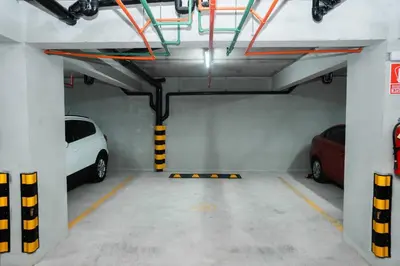 a parking garage with two cars parked in it at Hermoso departamento de 3 habitaciones in Lima