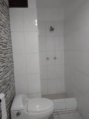 a white bathroom with a toilet and a shower at BONITO DEPARTAMENTO EN MIRAFLORES in Lima