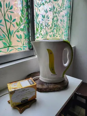 a vase sitting on a table next to a window at Private Cozy room with batroom in Miraflores in Lima