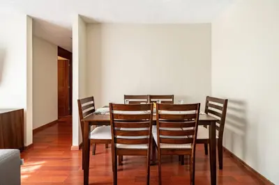 a dining room with a table and chairs at Apartamentos Estela en Alameda colonial - 5km Aeropuerto Jorge Chávez in Lima