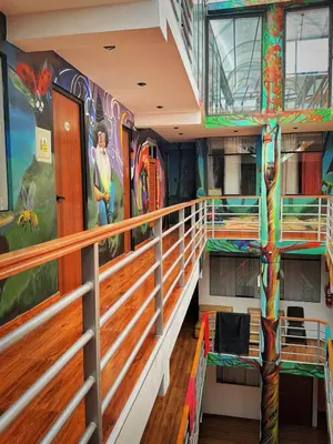 a second level of a cruise ship with a mural on the wall at Magic Packer Hostel in Cusco