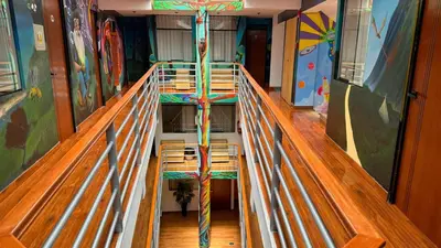 a hallway with a ladder in a room with a climbing gym at Magic Packer Hostel in Cusco