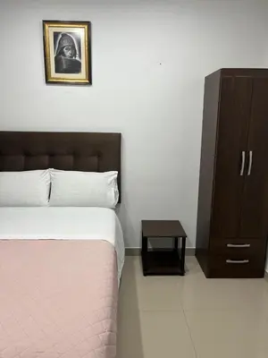 a bedroom with a bed and a cabinet with a picture at MH Apartments Ica 3 in Ica