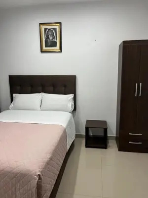 a bedroom with a bed and a dresser and a cabinet at MH Apartments Ica 3 in Ica
