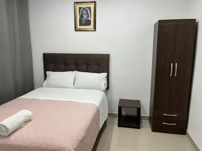 a bedroom with a bed and a dresser in it at MH Apartments Ica 3 in Ica