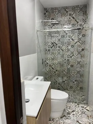 a bathroom with a toilet and a glass shower at MH Apartments Ica 3 in Ica