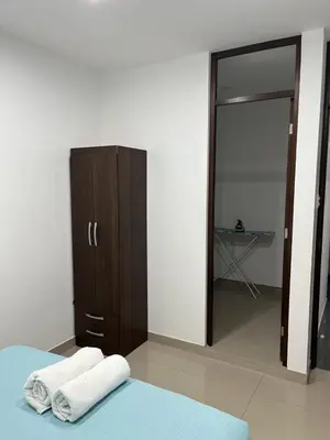 a bedroom with a wardrobe and two towels on a bed at MH Apartments Ica 3 in Ica