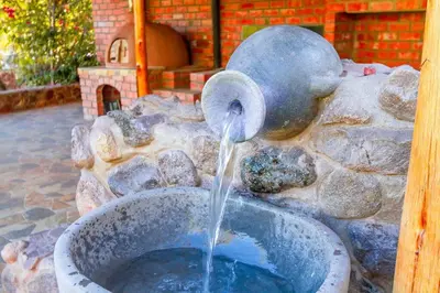 a water fountain in a stone wall at Suite Panorámico 304 in Urubamba