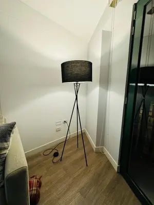 a lamp in the corner of a room next to a bed at Amazing 2BR in Barranco in front of CENTRAL restaurant in Lima