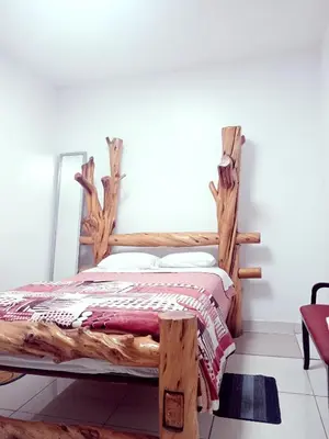 a bedroom with a bed made out of logs at Bellavista in Lima