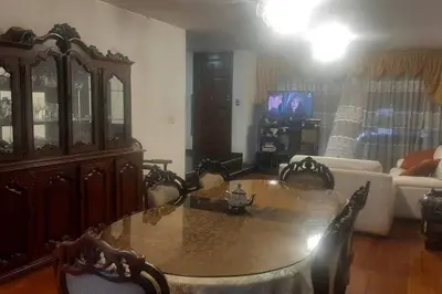 a living room with a table and a couch at Amplio Departamento Residencial en La Molina in Lima