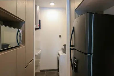 a kitchen with a refrigerator in a small room at Morada by Wynwood House in Lima
