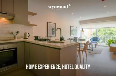 a kitchen with a stove top oven next to a living room at Morada by Wynwood House in Lima